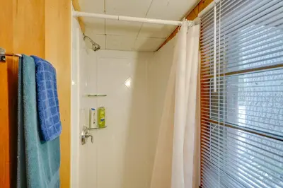 a bathroom with a shower and a shower curtain at Rustic Berkshires Cottage at Lake Buel with Kayaks! in New Marlborough