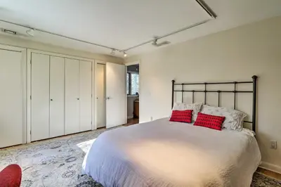 a bedroom with a large bed with red pillows at Peaceful Goshen Cottage with Screened Porch and Views! in Goshen