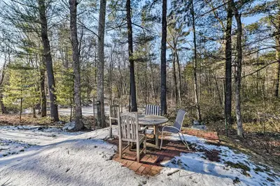 two chairs and a table in the snow at Peaceful Goshen Cottage with Screened Porch and Views! in Goshen
