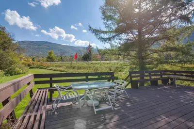 a wooden deck with a table and chairs on it at Hunter Hideaway with Yard and Deck 3 Mi to Ski Slopes in Hunter