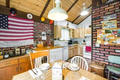 a kitchen with an american flag on the wall at Hunter Hideaway with Yard and Deck 3 Mi to Ski Slopes in Hunter