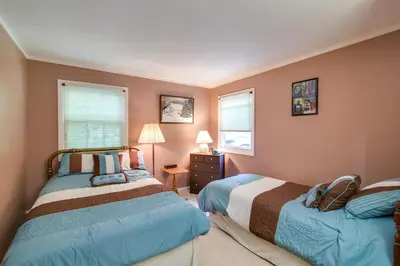 a bedroom with two beds and two windows at Hunter Hideaway with Yard and Deck 3 Mi to Ski Slopes in Hunter