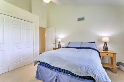a bedroom with a bed and a table with two lamps at Private Dog-Friendly Home 3 Mi to Elk Mountain in Union Dale