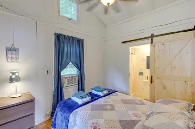 a bedroom with a bed and a window and a door at Massachusetts Lake House with Dock - Pets Welcome! in New Marlborough