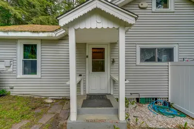 a white house with a white door and a porch at Massachusetts Lake House with Dock - Pets Welcome! in New Marlborough