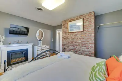 a bedroom with a bed and a fireplace at Slope Views Luxe Windham Retreat with Hot Tub! in Windham