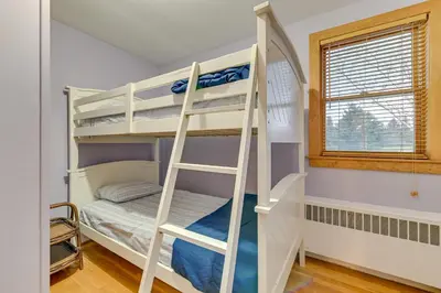 a bunk bed room with two bunk beds and a ladder at Slope Views Luxe Windham Retreat with Hot Tub! in Windham