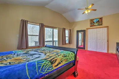 a bedroom with a tiger bed and a ceiling fan at Cozy Retreat with Deck and Hot Tub, 20 mins to Kalahari in Tobyhanna