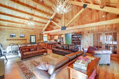 a living room with leather furniture and a wooden ceiling at 4 Mi to Mount Snow West Dover Cabin with Game Room in West Dover