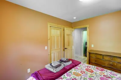 a bedroom with a bed and a dresser in it at 4 Mi to Mount Snow West Dover Cabin with Game Room in West Dover