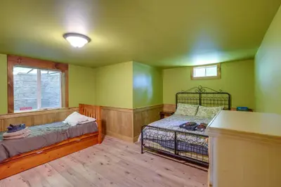 a bedroom with a bed and a window at 4 Mi to Mount Snow West Dover Cabin with Game Room in West Dover