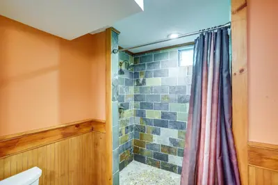 a bathroom with a shower with a shower curtain at 4 Mi to Mount Snow West Dover Cabin with Game Room in West Dover