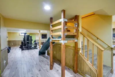 a loft bed in a room with a staircase at 4 Mi to Mount Snow West Dover Cabin with Game Room in West Dover