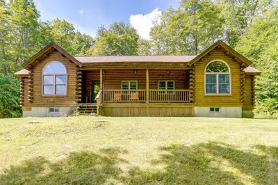 a log home with a large yard in front of it at 4 Mi to Mount Snow West Dover Cabin with Game Room in West Dover