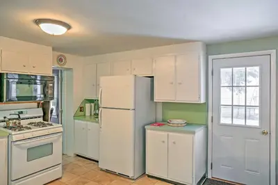 a kitchen with white appliances and a white refrigerator at Saratoga Springs Apt - Walk to Town and Race Track! in Saratoga Springs