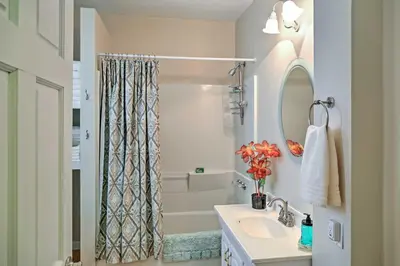 a bathroom with a sink and a shower curtain at Saratoga Springs Apt - Walk to Town and Race Track! in Saratoga Springs