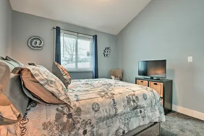 a bedroom with a bed and a flat screen tv at Near Mt Airy Casino Mount Pocono Condo with Balcony in Mount Pocono