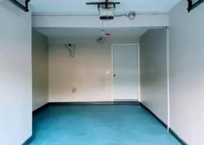 an empty room with a blue floor and a door at Chic with Recliner at Webster Hill Suite 1W Request Xtra Bed in New Britain
