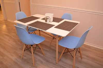 a table with blue chairs around it with a napkin on it at La Casita Bonita Near NYC in Yonkers