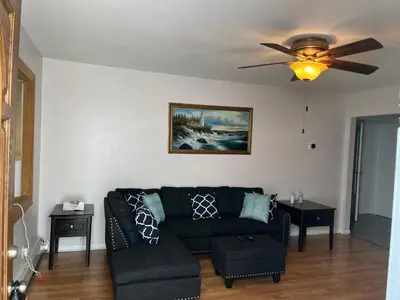 a living room with a couch and a ceiling fan at La Casita Bonita Near NYC in Yonkers