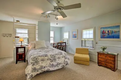 a bedroom with a bed and a ceiling fan at Charming Tivoli Home with Patio, by Town and Shops in Tivoli