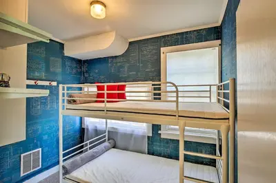 a bunk bed in a room with blue walls at Charming Tivoli Home with Patio, by Town and Shops in Tivoli