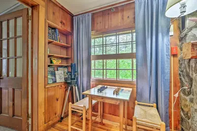 a dining room with a table and a window at Charming Wilmington Cabin, 8 Mi to Mt Snow! in Wilmington