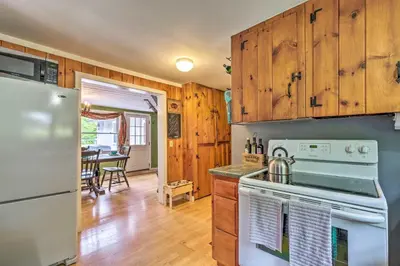 a kitchen with a stove and a refrigerator at Charming Wilmington Cabin, 8 Mi to Mt Snow! in Wilmington