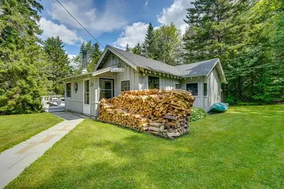 a pile of fire wood in front of a house at Charming Wilmington Cabin, 8 Mi to Mt Snow! in Wilmington