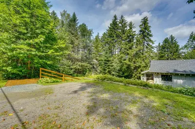 a home with a driveway and a house at Charming Wilmington Cabin, 8 Mi to Mt Snow! in Wilmington