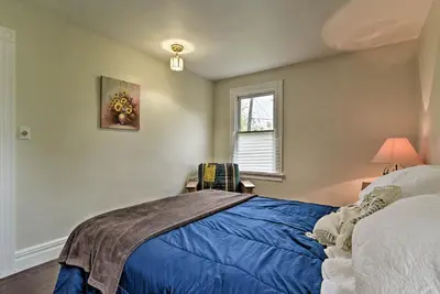 a bedroom with a blue bed and a window at Millburn House with Deck - Walk to NYC Transit! in Millburn