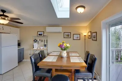 a kitchen and dining room with a table and chairs at Catskills Home, 5 Mins to Windham Mtn Resort! in Windham