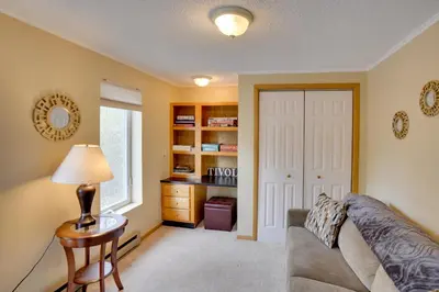 a living room with a couch and a table and a window at Catskills Home, 5 Mins to Windham Mtn Resort! in Windham