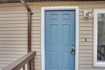 a blue door on a house with a porch at Catskills Home, 5 Mins to Windham Mtn Resort! in Windham