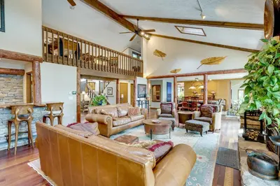 a large living room with leather furniture and a fireplace at Luxe Poconos Pines Home with Beach and Amenities! in Pocono Pines