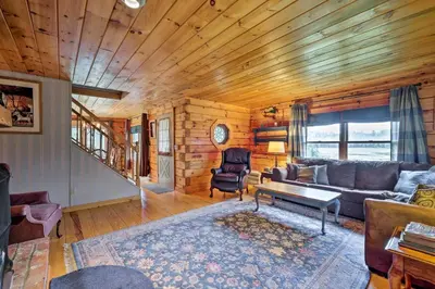a living room with a couch and a table at Jacksonville Cabin with Wraparound Deck and Views in Jacksonville