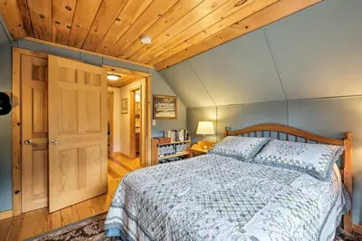 a bedroom with a bed and a wooden ceiling at Jacksonville Cabin with Wraparound Deck and Views in Jacksonville