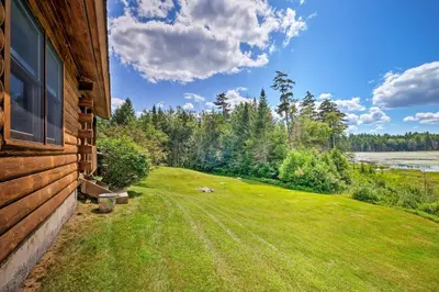 a view of a yard next to a house at Jacksonville Cabin with Wraparound Deck and Views in Jacksonville