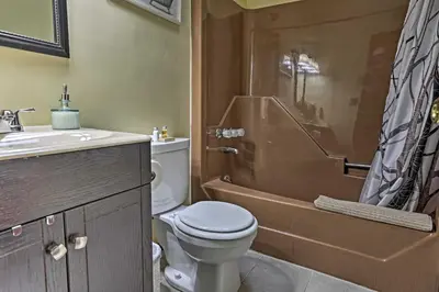 a bathroom with a toilet and a sink and a shower at 15 Mi to Camelback Ski Resort Home with Deck! in Tobyhanna