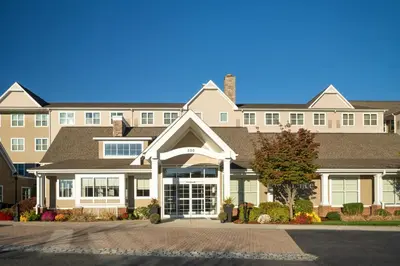 a large apartment building with a driveway in front of it at Residence Inn by Marriott Springfield Chicopee in Chicopee