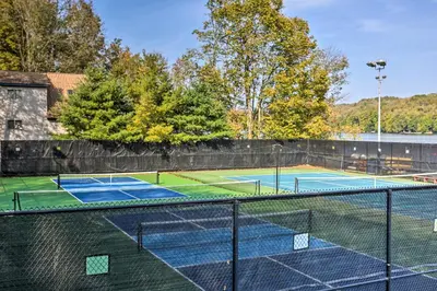a tennis court with two tennis courts at half Mi to Hideout Ski Lake Ariel Resort Home! in Lake Ariel