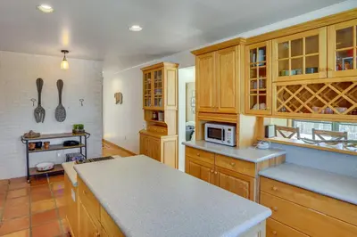 a kitchen with wooden cabinets and a counter top at Wilmington Retreat with Deck, Lake Views and Game Room in Wilmington