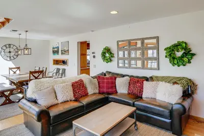 a living room with a brown leather couch at Wilmington Retreat with Deck, Lake Views and Game Room in Wilmington