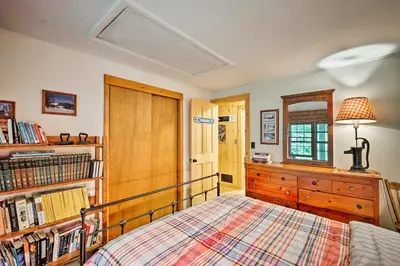 a bedroom with a bed and a dresser and a mirror at Private Wooded Cabin 7 Mi to Mount Snow! in Wilmington