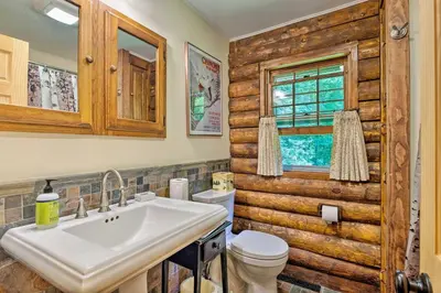 a bathroom with a toilet and a sink at Private Wooded Cabin 7 Mi to Mount Snow! in Wilmington
