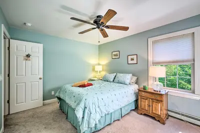 a bedroom with a bed and a ceiling fan at West Dover Home with Deck, Grill and EV Outlet in West Dover