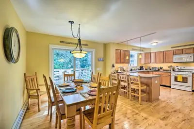 a kitchen and dining room with a table and chairs at West Dover Home with Deck, Grill and EV Outlet in West Dover