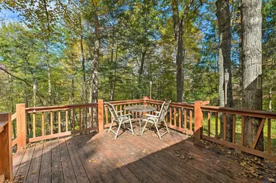 a wooden deck with a table and chairs on it at Catskill Mtn Home with Deck about 1 Miles to Zoom Flume! in East Durham