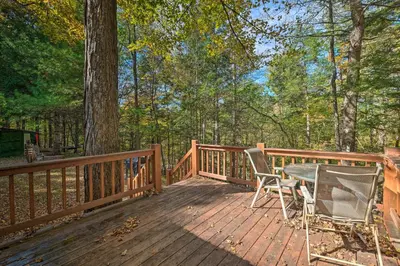a wooden deck with a table and chairs on it at Catskill Mtn Home with Deck about 1 Miles to Zoom Flume! in East Durham