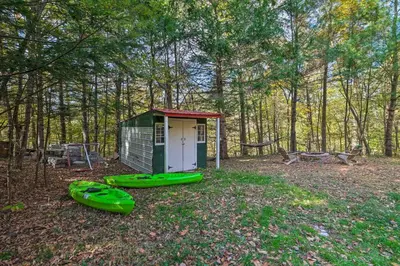 a small shack with two canoes in front of it at Catskill Mtn Home with Deck about 1 Miles to Zoom Flume! in East Durham